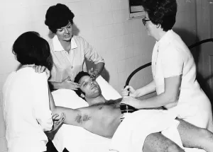 Tom Jones Singer pays a vist to a health farm laying on bed getting a massage