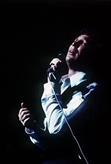 Tom Jones singer singing microphone open necked shirt
