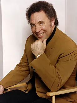 Tom Jones singer sits in chair