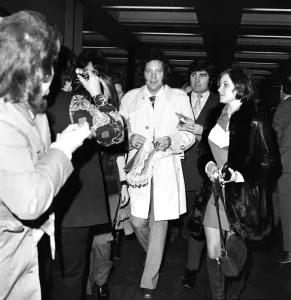 Tom Jones, surrounded by his fans, who bade him farewell as he left London for Los