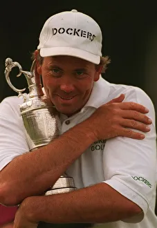 Tom Lehman hugs Claret jug trophy after winning British Open golf championship at Lytham