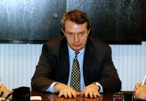 Tommy Gilmour boxing promoter press conference hans flat on table, October 1995