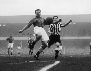00350 Prints: Tommy Jones of Everton gets the better of Newcaste centre forward White League Division