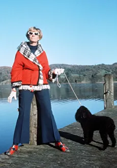00003 Prints: Tonia Campbell wife of Donald Campbell with poodle Coco watches as her husband