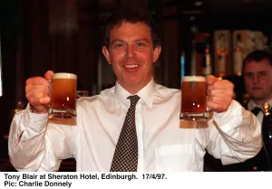 Tony Blair holding two half pints of Blairs Brew beer in both hands. April 1997
