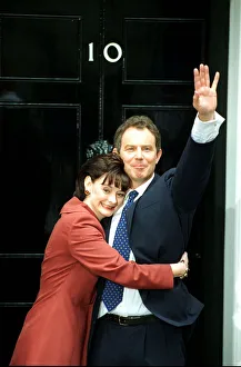 Tony Blair and wife Cherie stand at the door of 10 Downing Street waving to the crowd