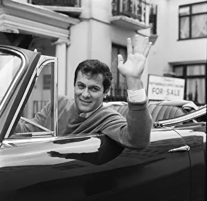 Tony Curtis, american actor poses for pictures in his Alvis TE21 motorcar in
