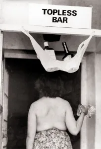 Sign Prints: Topless bar sign above a pub door with a bra hooked up holding two bottles of spirits one
