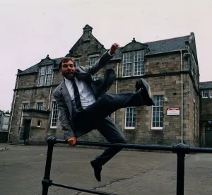 Bill Torrance - Singer TV Presenter jumping over fence at Broxburn Primary