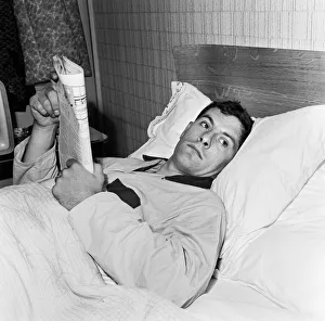 Recuperation Prints: Tottenham and England footballer Alan Mullery lies flat out in bed at his Worcester Park