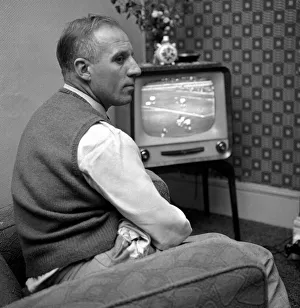 00208 Prints: Tottenham Hostpur footballer Eddie Bailey at home watching a match on the television