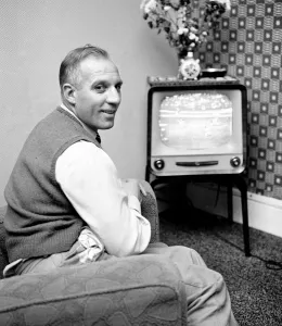 00440 Prints: Tottenham Hostpur footballer Eddie Bailey at home watching a match on the television