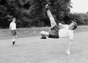 00328 Prints: Tottenham Hotspur footabller Cliff Jones tries a spectacular overhead kick during a