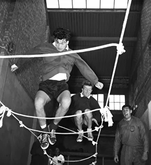 Skill Prints: Tottenham Hotspur footballers Ron Henry and Terry Dyson using a rope ladder during a team