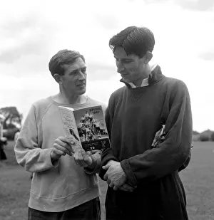 Tottenham Hotspur players Danny Blanchflower and goalkeeper Bill Brown holding a copy of