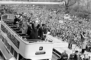 Tottenham Hotspur players parade the FA Cup trophy from the top of an open top double