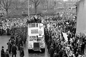 Tottenham Hotspur players parade the FA Cup trophy from the top of an open top double