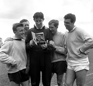 Tottenham Hotspur players reading a copy of the Spurs book called Spurs 1961
