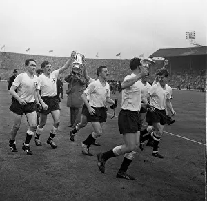 Tottenham Hotspur players run around with the FA Cup 1962 celebrating including