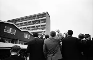 Tottenham Hotspur team hold the FA Cup trophy aloft to fans watching the parade from a