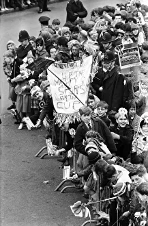 Tottenham Hotspur team hold the FA Cup trophy aloft from an open top double decker bus to