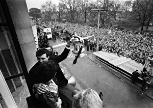 Tottenham Hotspur team hold the FA Cup trophy aloft at Tottenham Town Hall to a crowd of