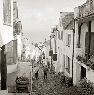Landscapes And Gardens Prints: Tourists making their way down the steep hill in the village of Clovelly in North Devon