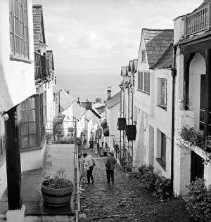 Landscape Prints: Tourists making their way down the steep hill in the village of Clovelly in North Devon