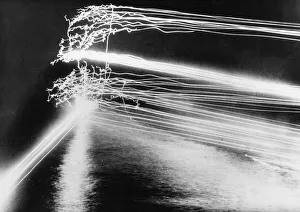 Us Navy Prints: Tracer bullets light up the night sky as guns from a US Navy warship pout their fire on a