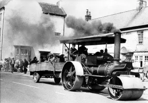 Vintage Prints: This traction engine steam roller is taking people for a ride in a trailer on 19th May