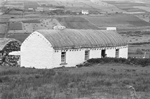One of the traditional farmhouses with a thatched roof over looking the fields