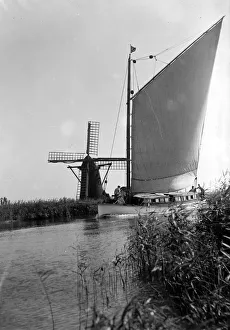 Air Pollution Prints: A traditional Norfolk Broad yachts sailing past one of the many windmill water pumps that