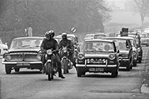 Queue Prints: Traffic including three motorcyclists stop and queue along the A556 towards Manchester