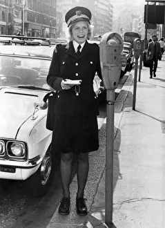 Traffic Warden, Denise Taylor, looks at a parking meter in London. August 1973 P018265