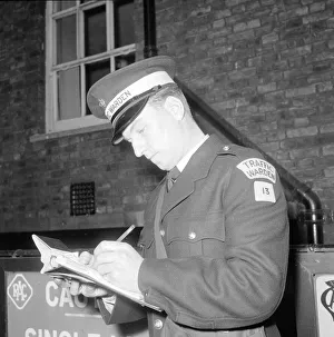 Square Prints: Traffic warden during training writing a fine fining uniform