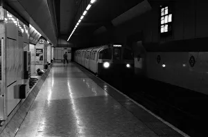 00133 Prints: A train approaches the platform at Heathrow Airports terminal four tube station