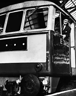 Stations Prints: A train driver poses in the cab of his British Rail express Class 86 electric locomotive