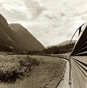 00273 Prints: A train goes through the Rocky Mountains from Vancouver to Banff. Canada