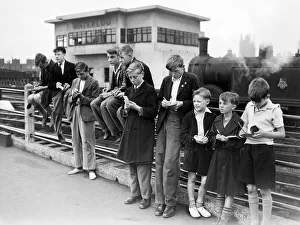Trainspotters gather at the end of the platform at Waterloo station. August 1952