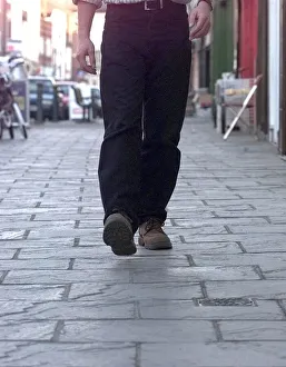 Cobbles Prints: Tread carefully... a pedestrian walks along Long Street on the controversial cobbles in