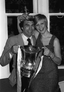 F A Cup Prints: Trevor Brooking with his wife holding the FA Cup at the reception for the West Ham team