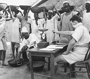Tributors having their concentrate assessed and weighed by the manager of a columbite