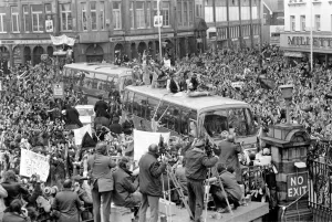 Triumphant West Ham players parade the FA cup trophy to their fans from an open top