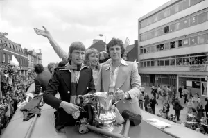 Triumphant West Ham players parade the FA cup trophy to their fans from an open top