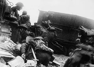 Troops of 3rd infantry division sheltering behind armoured vehicles on Queen Beach
