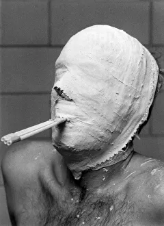 Ice Hockey Prints: Tubes in his mouth help Ice Hockey goal minder Leif Holmquist to breathe as he waits for