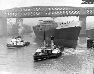 Tugs Prints: Tugs move in to take hold of the ship Victoria City after the launch at William Doxford