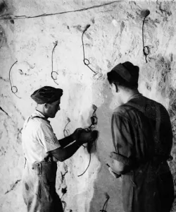 The Tunnellers'of the Royal Engineers lighting explosive fuses for blasting