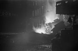 Fires Prints: A turntable ladder of the London Fire Brigade is silhouetted against fires close to