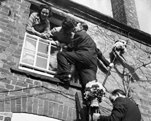 00076 Prints: The tutti-men climb a ladder to get the traditional kiss the window during the Hock-tide